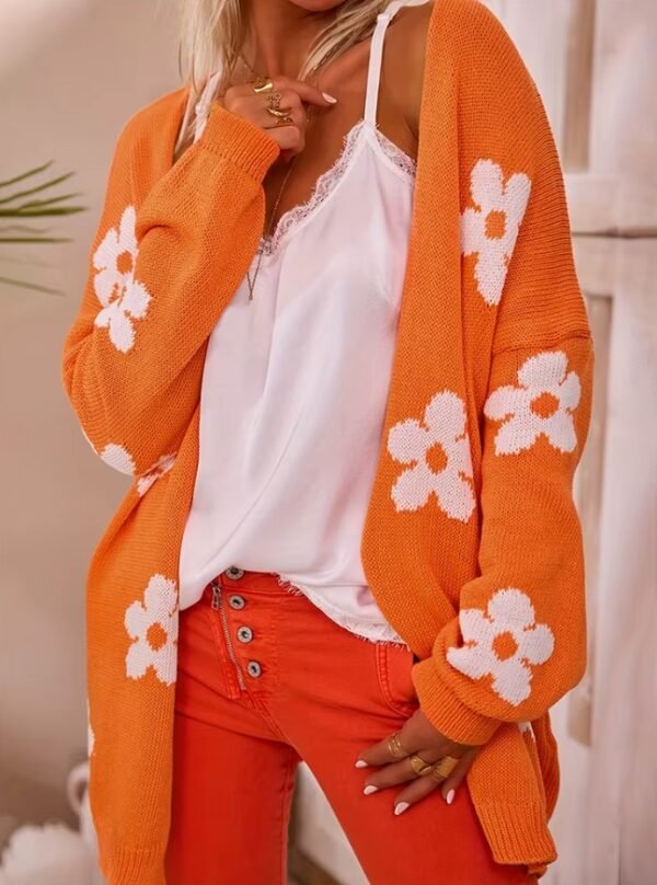 woman wearing orange color cardigan, white top and dark orange jeans