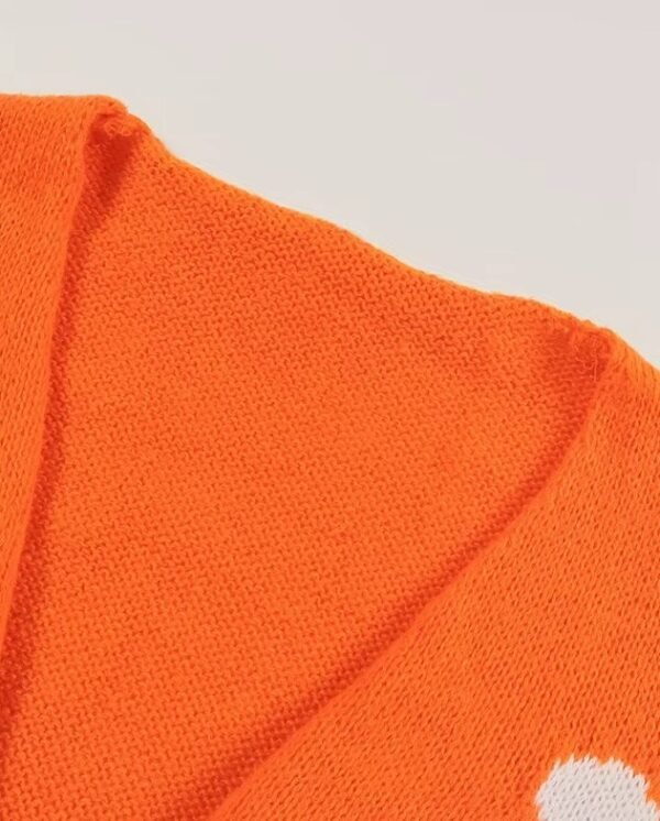 neck of orange color cardigan