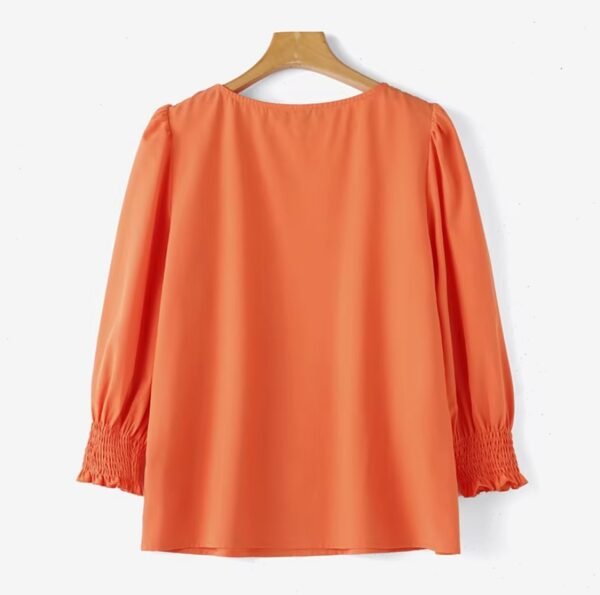 back view of orange colorful short-sleeved blouse