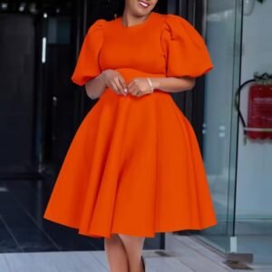 woman wearing orange dress, glass door behind her