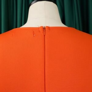 zipper of orange dress on a mannequin