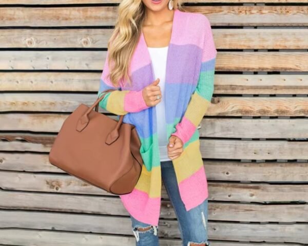 woman wearing pastel cardigan and jeans, she is holding a big brown bag