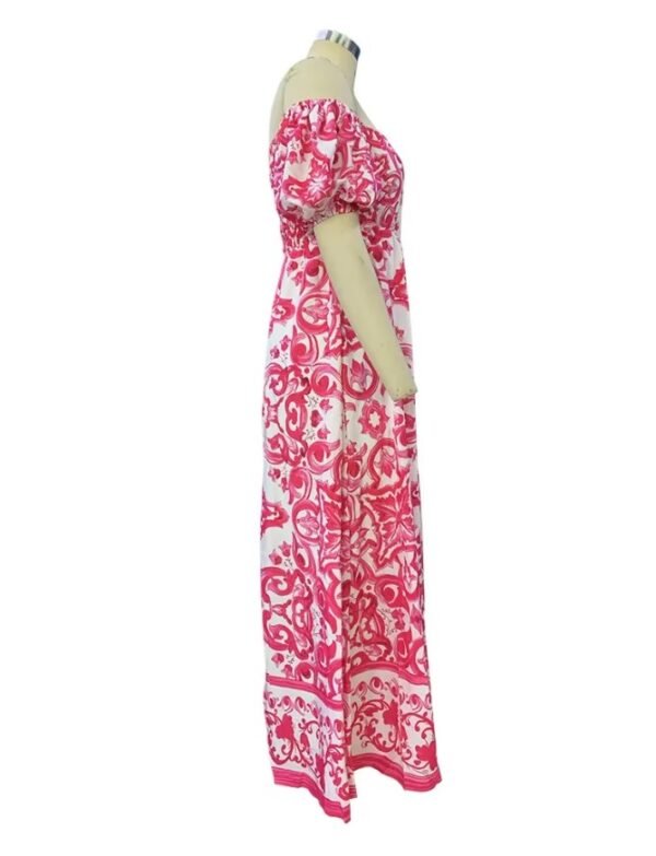 side view of pink colorful bohemian dress on a mannequin, white background