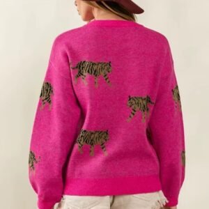 woman turned to her back wearing pink colorful tiger print sweater