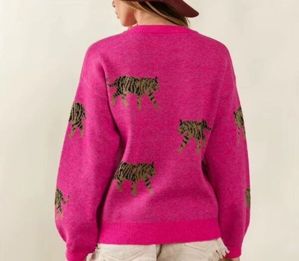 woman turned to her back wearing pink colorful tiger print sweater