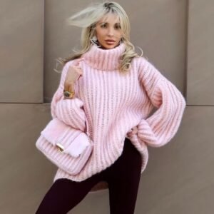 woman with blonde hair wearing pink colorful turtleneck sweater and black leggings