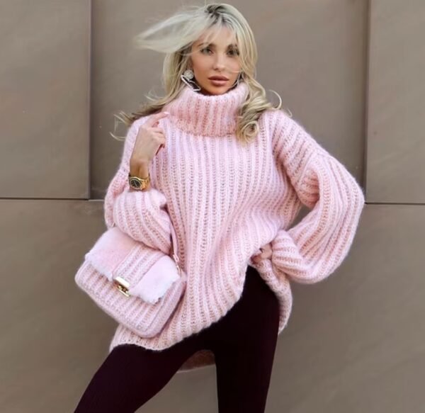 woman with blonde hair wearing pink colorful turtleneck sweater and black leggings