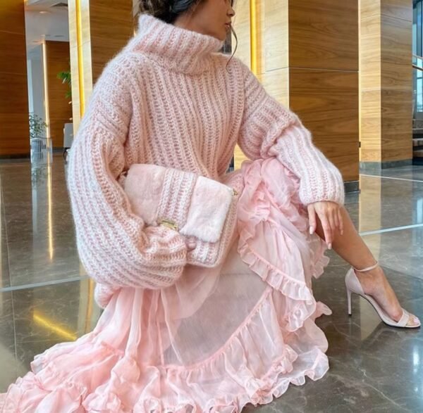 woman wearing pink colorful turtleneck sweater, pink tulle skirt, white heels and holding a pink purse