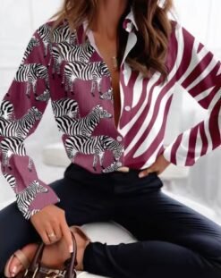 woman wearing pink colorful zebra blouse and black jeans