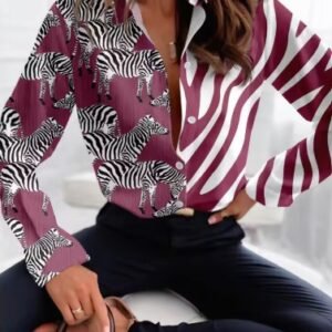 woman wearing pink colorful zebra blouse and black jeans