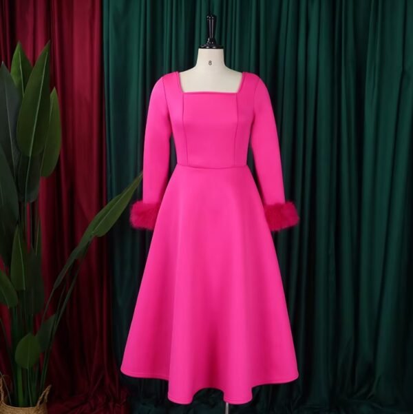 pink long-sleeved colorful dress, green and red curtains in the background