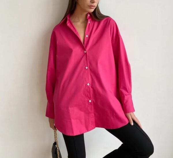 woman wearing pink oversized colorful blouse and black pants