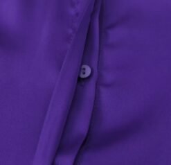the button of the purple blouse