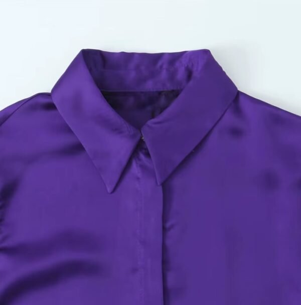 the collar of the purple blouse