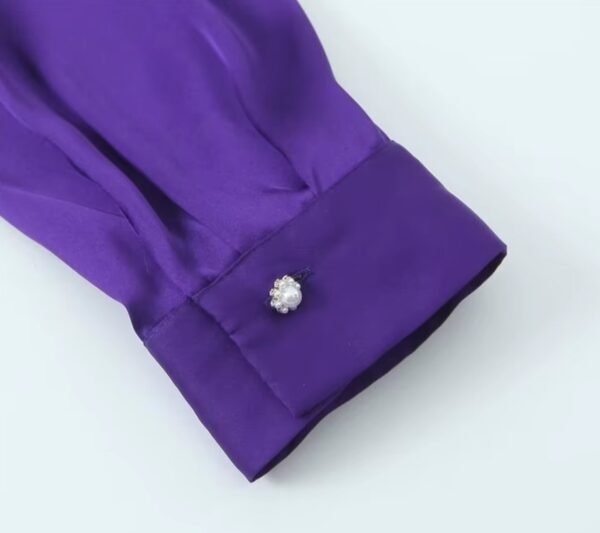 sleeve of purple blouse on the white background