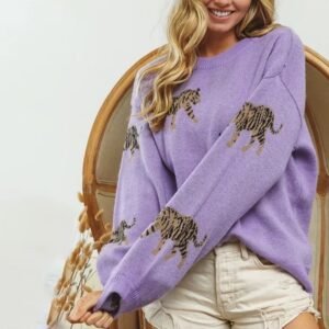 woman turning to her side and wearing purple colorful tiger print sweater