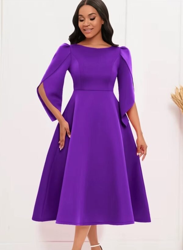 woman wearing purple modest colorful dress and white sandals, white wall behind her