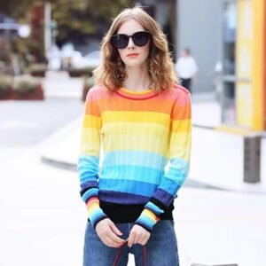 woman wearing rainbow sweater and jeans, she is standing on the street