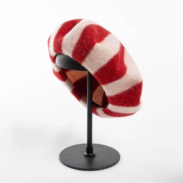 inside part of red colorful striped beret on a black pillar, white background