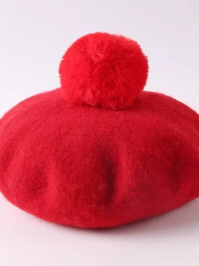 red colorful winter beret on the white background