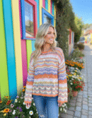woman with blonde hair wearing retro colorful sweater