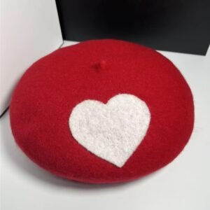 romantic colorful beret on the white table, a black box next to it