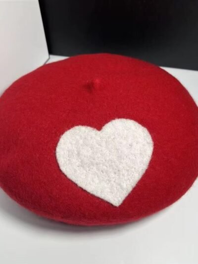 romantic colorful beret on the white table, a black box next to it