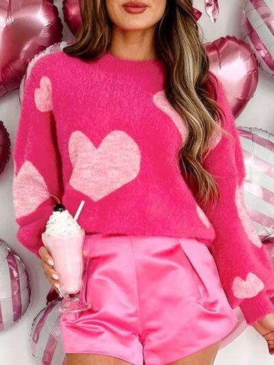 woman wearing romantic colorful sweater and pink shorts, she is holding a pink milkshake, pink balloons behind her