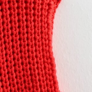 shoulder part of red sleeveless cardigan