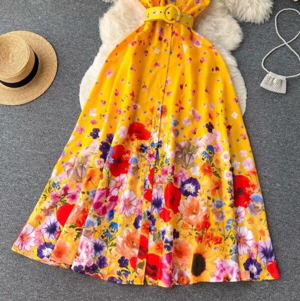 bottom part of spring colorful dress on a grey carpet, a beige hat and a silver purse next to it