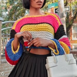 woman wearing stylish colorful sweater, black skirt and holding a white bag