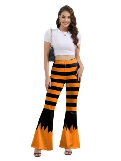 woman wearing Halloween pants, white top and brown purse, white background