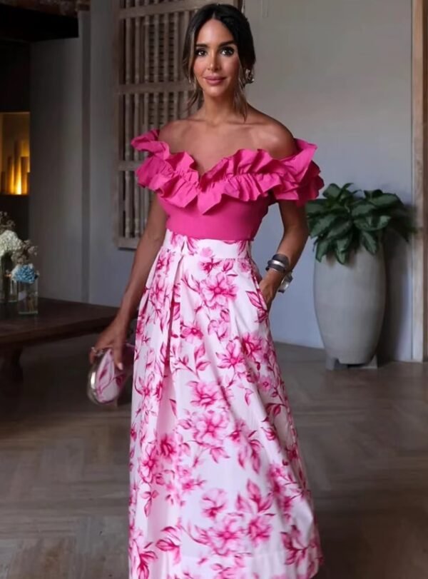 woman wearing Japanese colorful skirt and a pink top with ruffles, a room behind her