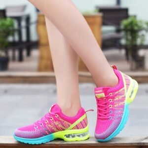 woman walking in athletic colorful sneakers on a grey ground