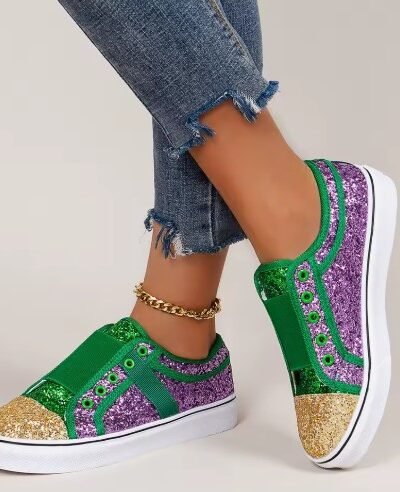 woman wearing bling colorful sneakers, jeans and a golden ankle bracelet