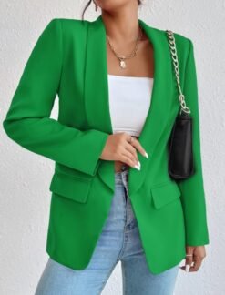 woman wearing green casual colorful blazer with jeans and holding the blazer's material