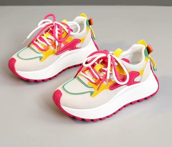 front view of casual colorful sneakers on the grey background