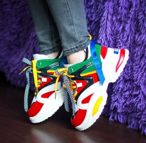 woman wearing chunky colorful sneakers and standing on her toer