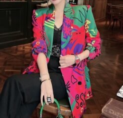 woman wearing colorful blazer for women and black pants, brown room in the backgorund