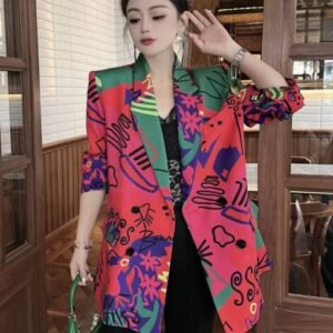 woman wearing colorful blazer for women and black pants, she is carrying a green bag