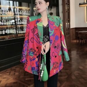 woman wearing colorful blazer for women over a black top, restaurant in the backgorund