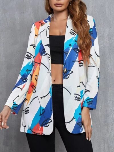 woman wearing colorful blazer with faces, black top and black pants, grey background