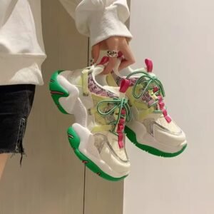 woman holding colorful color blocking sneakers