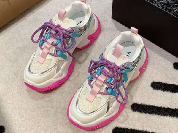 colorful color blocking sneakers lying on a white floor