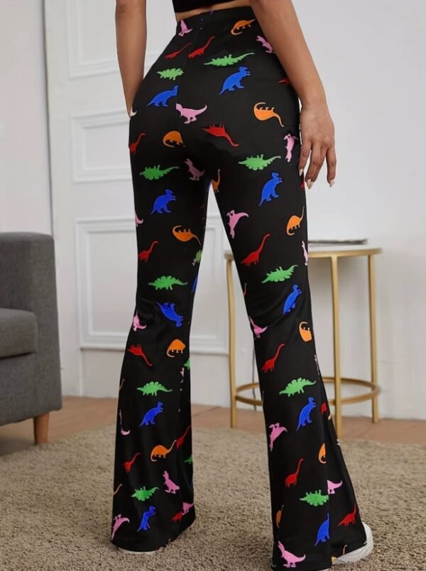 woman turned to her back wearing colorful dinosaur pants, beige room in the background