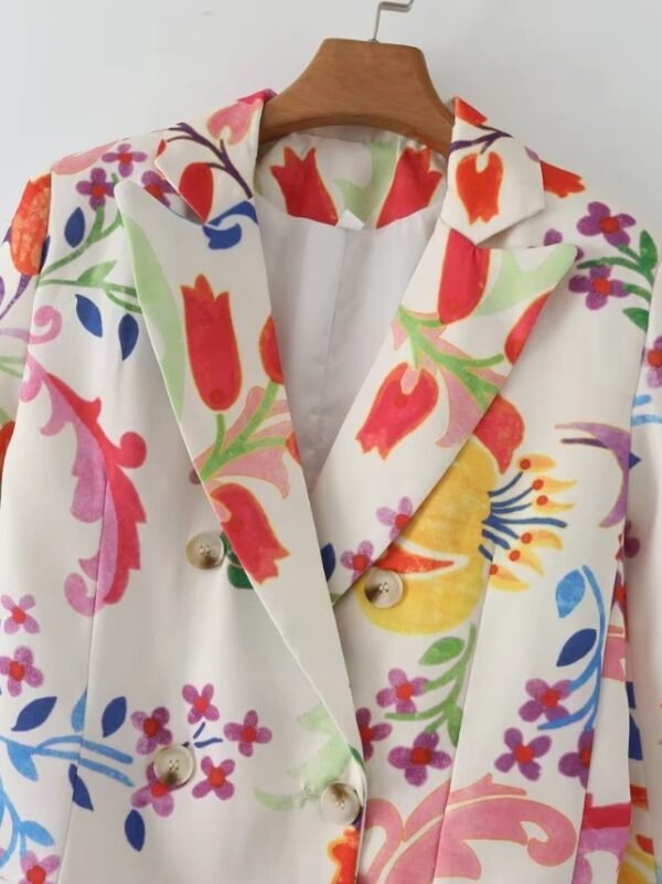 collar of colorful floral blazer on a hanger