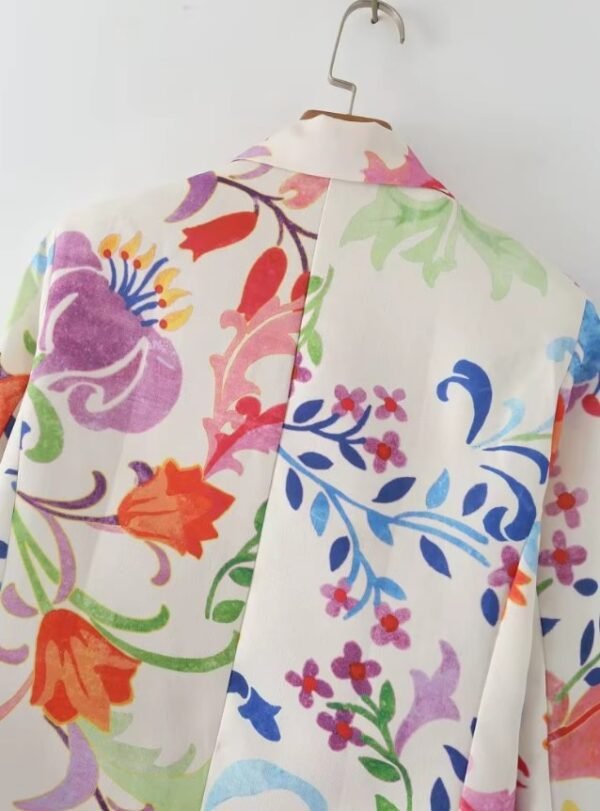 back view of upper part of colorful floral blazer on a hanger