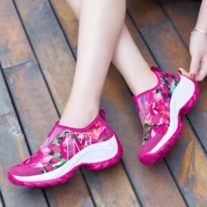 woman wearing colorful floral sneakers and touching their material