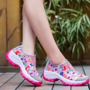 woman wearing light pink colorful floral sneakers