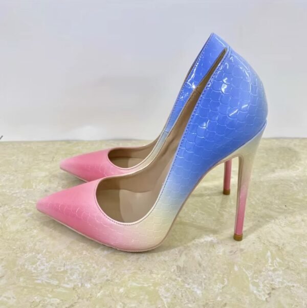 side view of colorful gradient heels on the beige background